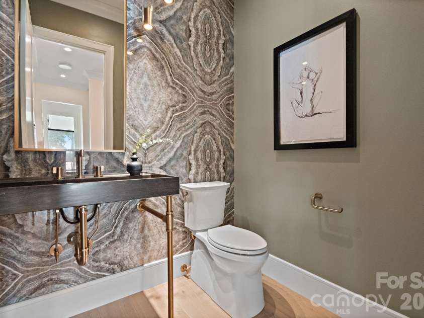 127 Tinker Place, Troutman, NC 28166.  MLS# CAR4394481, YatesRealty ID 15255. Stunning tile accent wall in main level half bathroom