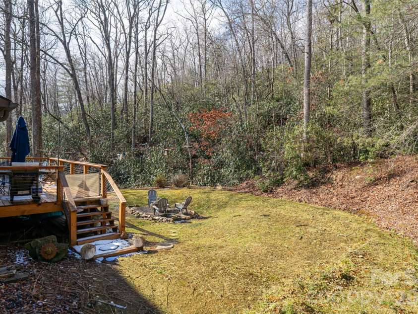 19 Forge Drive, Mills River, NC 28759.  MLS# CAR4344068, YatesRealty ID 1526. Lush Landscaping and MatureTrees Frame the Home