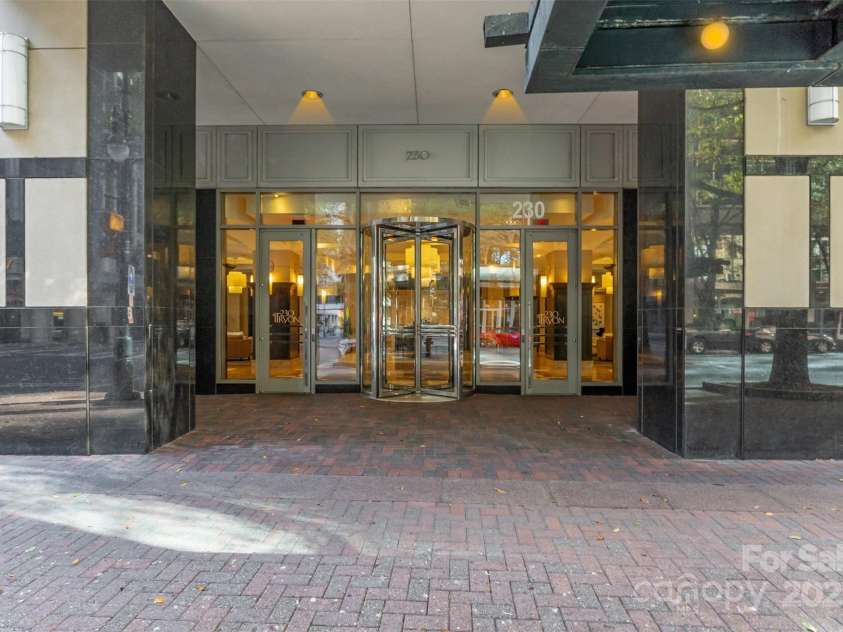 230 Tryon Street, Charlotte, NC 28202.  MLS# CAR4321048, YatesRealty ID 1527. Front Entrance to Building and Concierge from South Tryon Street, Uptown Charlotte