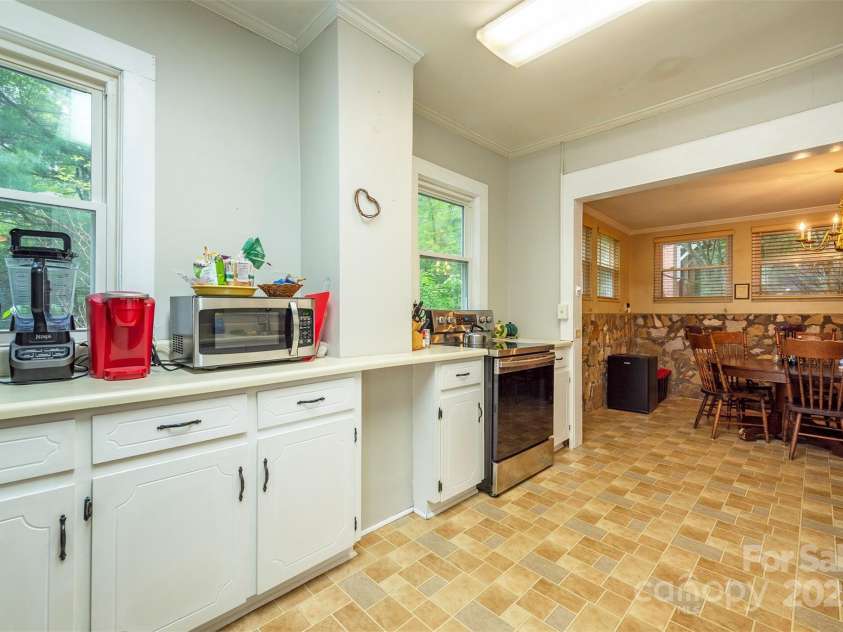 223 Assembly Drive, Montreat, NC 28757.  MLS# CAR4256904, YatesRealty ID 15288. Kitchen adjoins stone dining area.