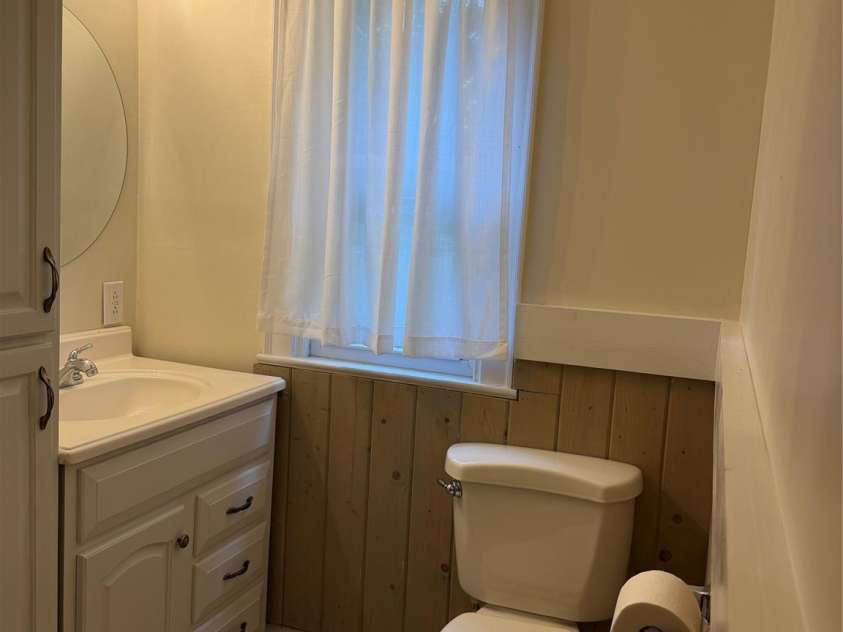612 Ballard Street, Chester, SC 29706.  MLS# CAR4355125, YatesRealty ID 15297. This light-filled bathroom combines everyday functionality with rustic charm, featuring, a bright window that fills the space with natural light, and attractive wood accent walls for a cozy feel
