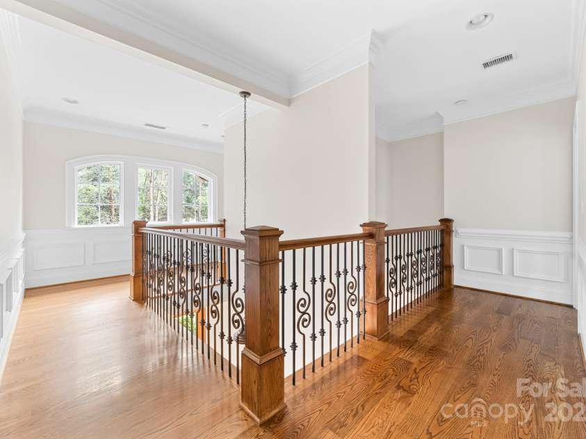 14504 Henry Harrison Stillwell Drive, Huntersville, NC 28078.  MLS# CAR4288907, YatesRealty ID 1530. Primary staircase with decorative iron rail
