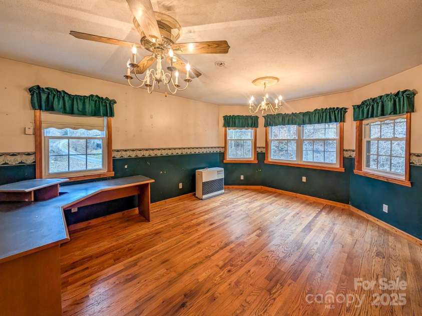 77 Griffith Branch Road, Green Mountain, NC 28740.  MLS# CAR4328405, YatesRealty ID 1531. Den/Flex space offers verstility for additional living area, den, dining room, office - whatever you might decide to utilize it for. Featuring hardwood flooring and kerosene monitor for supplemental heat source