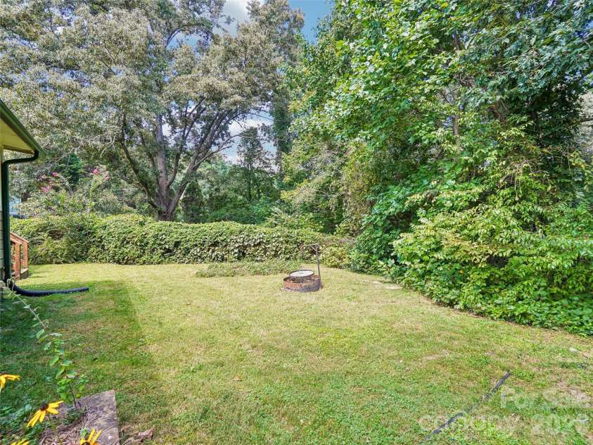 75 Cisco Road, Asheville, NC 28805.  MLS# CAR4425797, YatesRealty ID 15312. Level lot lovingly planted for year round enjoyment