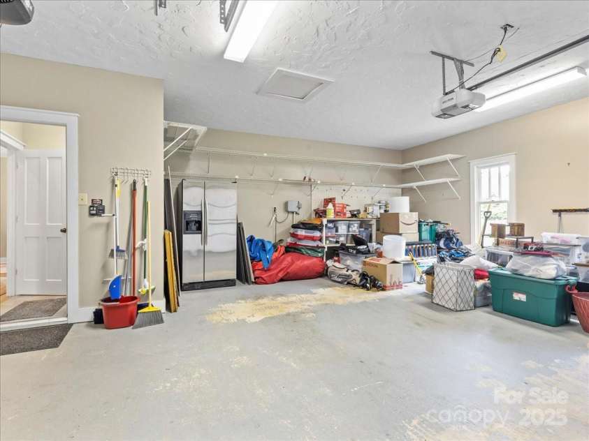 28 Lacoste Drive, Hendersonville, NC 28739.  MLS# CAR4246856, YatesRealty ID 15335. Large garage with storage and golf cart door
