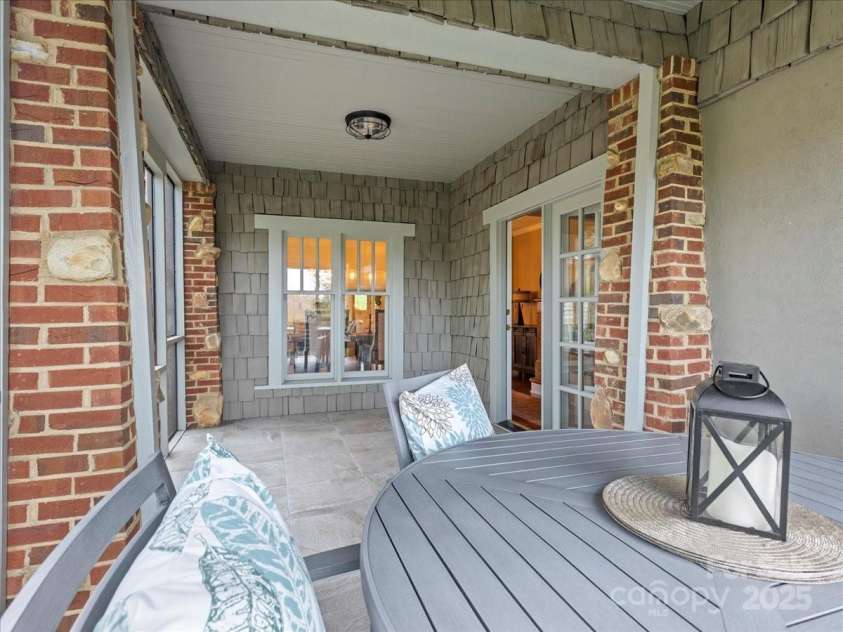 28 Lacoste Drive, Hendersonville, NC 28739.  MLS# CAR4246856, YatesRealty ID 15335. Screened side porch off living aread