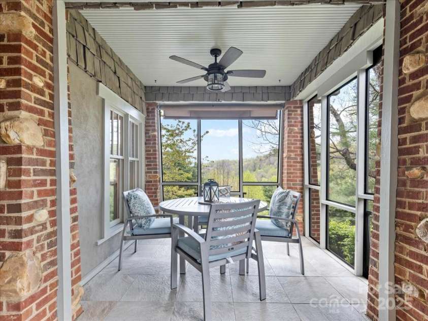 28 Lacoste Drive, Hendersonville, NC 28739.  MLS# CAR4246856, YatesRealty ID 15335. Screened side porch off owner suite
