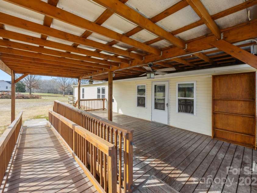 21465 Old Beatty Ford Road, Gold Hill, NC 28071.  MLS# CAR4326908, YatesRealty ID 1535. Back covered deck features a ramp