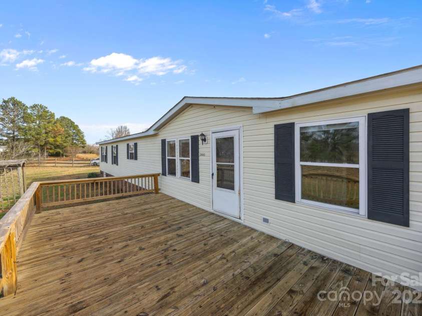 21465 Old Beatty Ford Road, Gold Hill, NC 28071.  MLS# CAR4326908, YatesRealty ID 1535. Front entry way has a large deck to enjoy