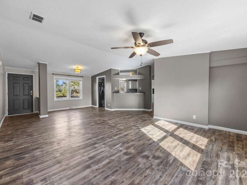 21465 Old Beatty Ford Road, Gold Hill, NC 28071.  MLS# CAR4326908, YatesRealty ID 1535. Large living room features fireplace and lots of natural light