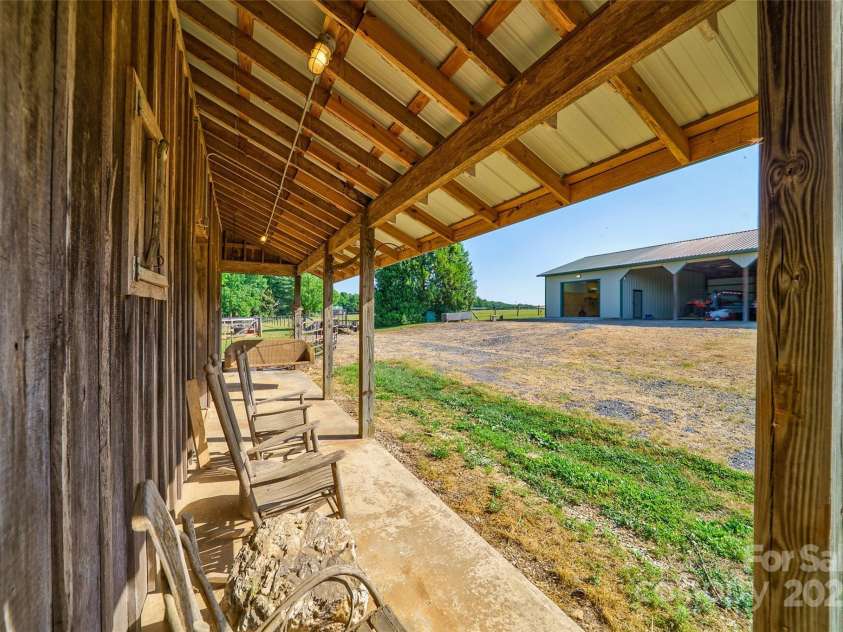 3400 Baucom Manor Road, Monroe, NC 28110.  MLS# CAR4250863, YatesRealty ID 15352. Rocking chair barn cover porch