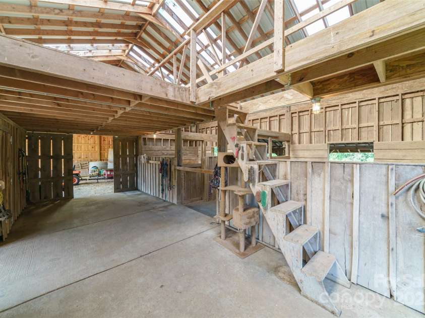 3400 Baucom Manor Road, Monroe, NC 28110.  MLS# CAR4250863, YatesRealty ID 15352. Tack room, feed room, hay loft, concrete center aisle
