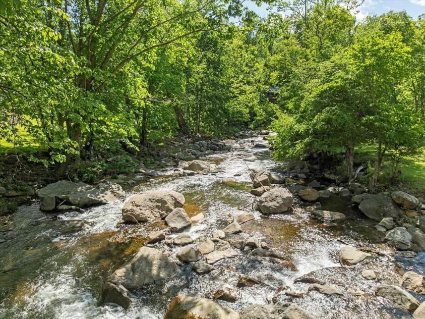 1786 Fork Mountain Road, Bakersville, NC 28705.  MLS# CAR4264003, YatesRealty ID 15363. Little rock creek that can be seen and heard from the rear deck.