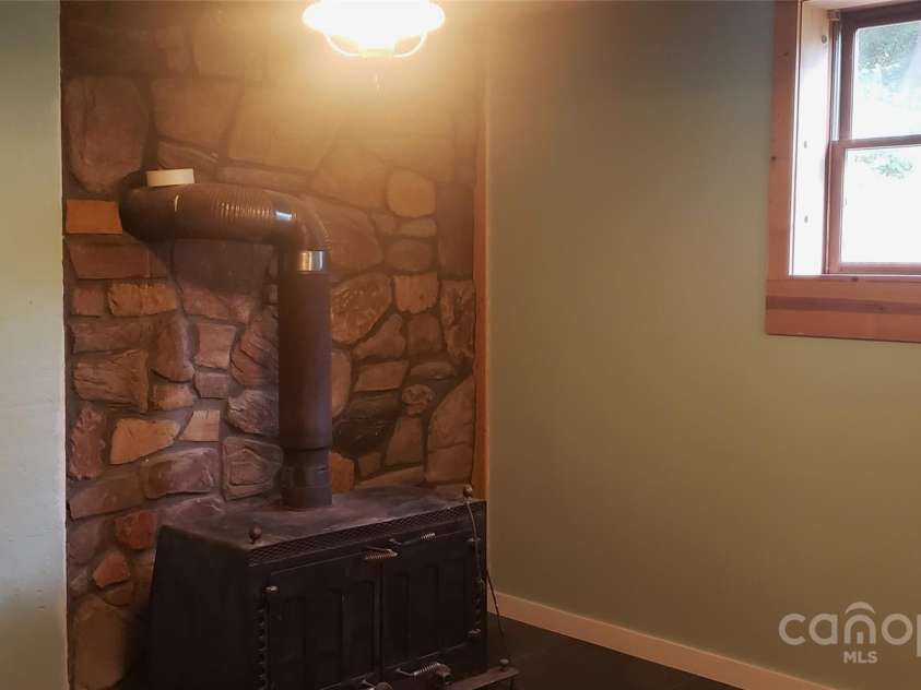 4755 US 23 Highway, Mars Hill, NC 28754.  MLS# CAR4285920, YatesRealty ID 1537. Den wood stove