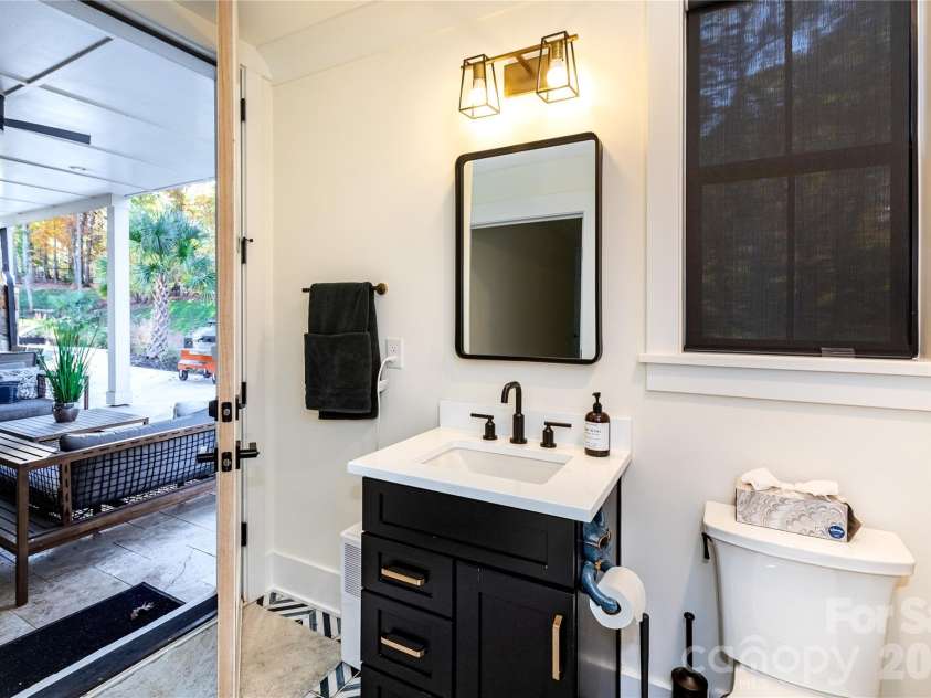 124 Direct Drive, Mooresville, NC 28117.  MLS# CAR4359656, YatesRealty ID 15382. Bathroom opens to outside for easy access from the pool