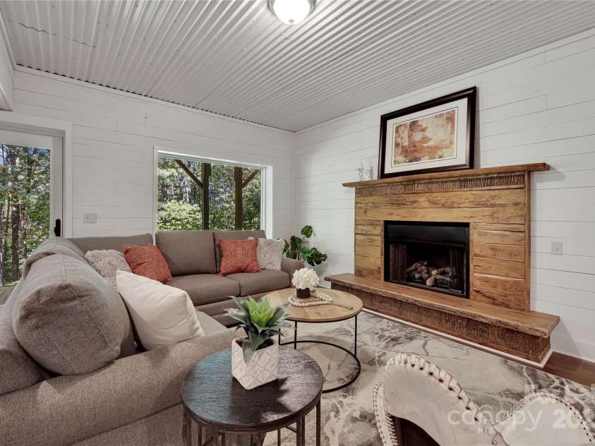 224 Corsica Lane, Saluda, NC 28773.  MLS# CAR4294125, YatesRealty ID 15383. Family room with plenty of windows and gas log fireplace