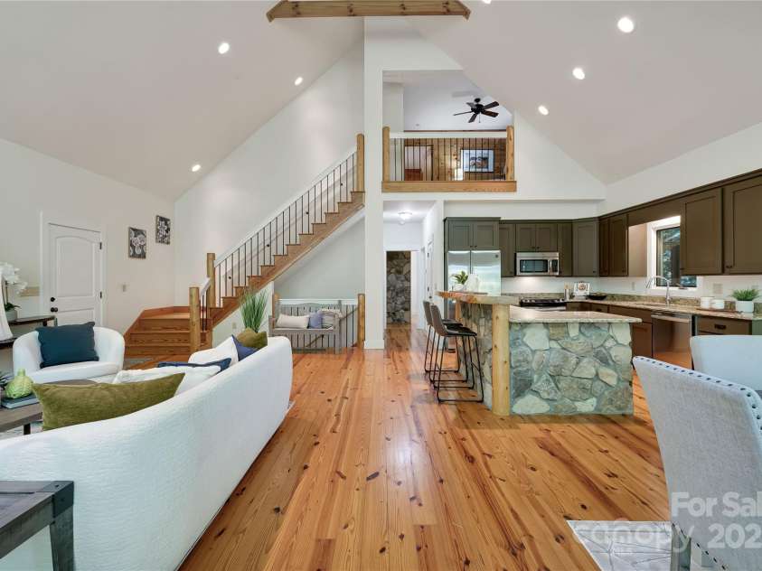 224 Corsica Lane, Saluda, NC 28773.  MLS# CAR4294125, YatesRealty ID 15383. Just down the hallway is the primary suite, another full bathroom for guests, the laundry and pantry.