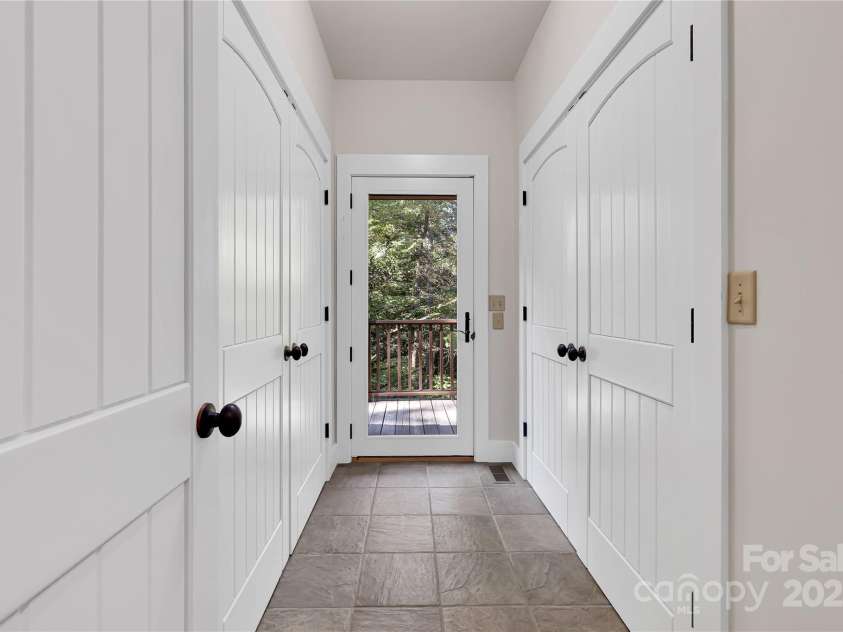 224 Corsica Lane, Saluda, NC 28773.  MLS# CAR4294125, YatesRealty ID 15383. Side entrance that leads to the garage with pantry and laundry closets.