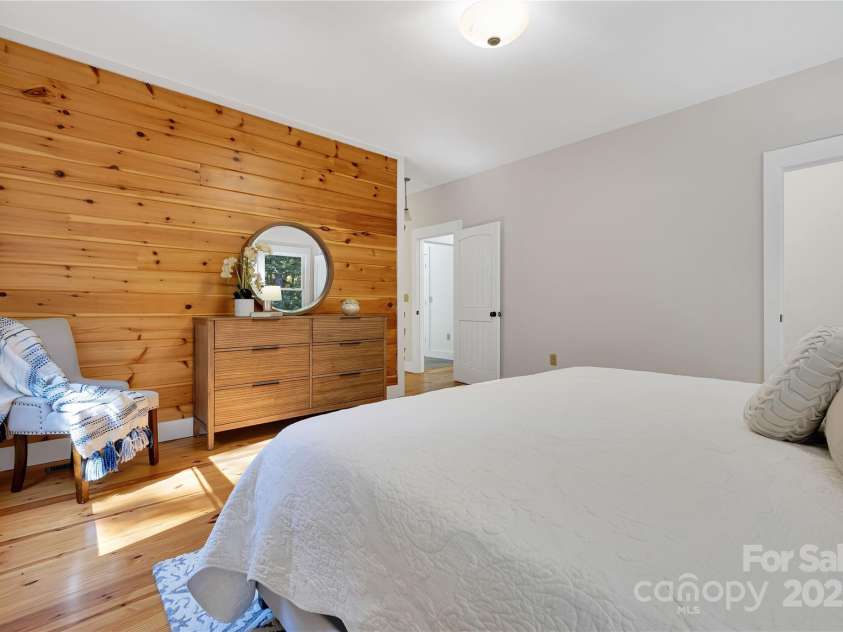 224 Corsica Lane, Saluda, NC 28773.  MLS# CAR4294125, YatesRealty ID 15383. Wood wall accent in primary bedroom