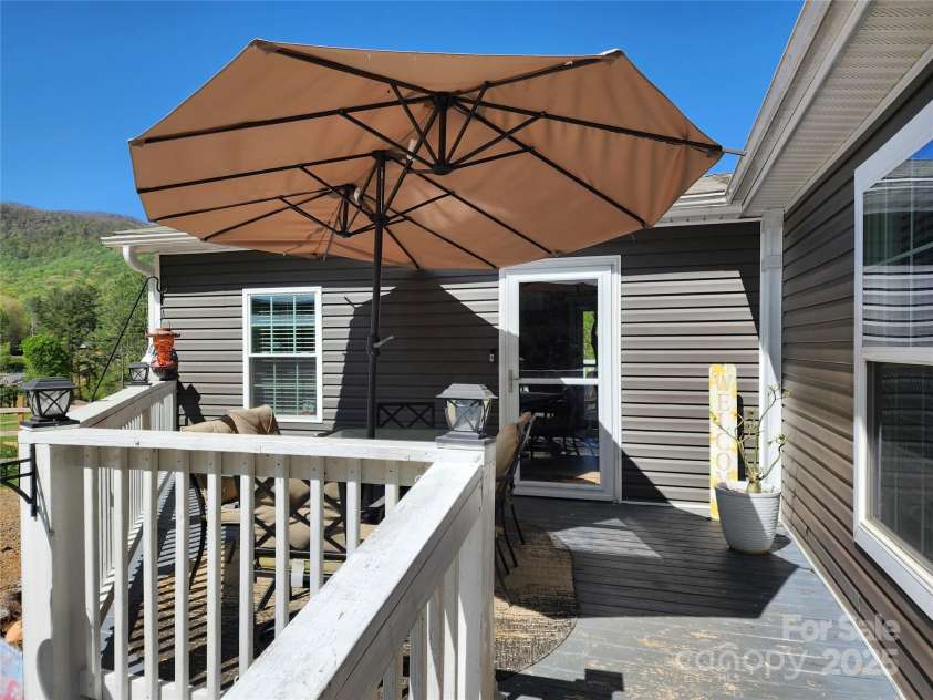 583 Cane Branch Road, Burnsville, NC 28714.  MLS# CAR4251066, YatesRealty ID 15423. Deck and primary entrance to the house