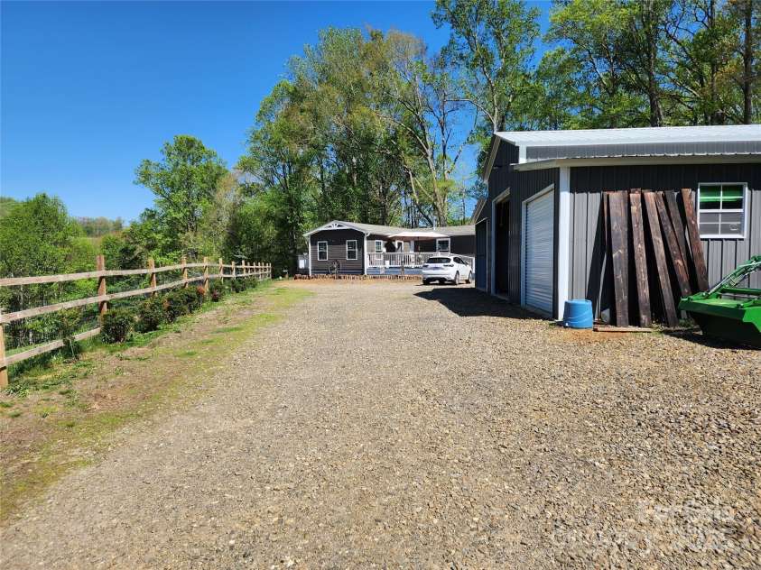 583 Cane Branch Road, Burnsville, NC 28714.  MLS# CAR4251066, YatesRealty ID 15423. Driveway leading to the house with garage on the right