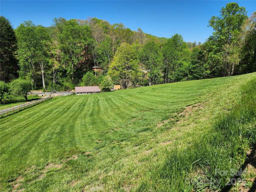 583 Cane Branch Road, Burnsville, NC 28714.  MLS# CAR4251066, YatesRealty ID 15423. Fully fenced front green area