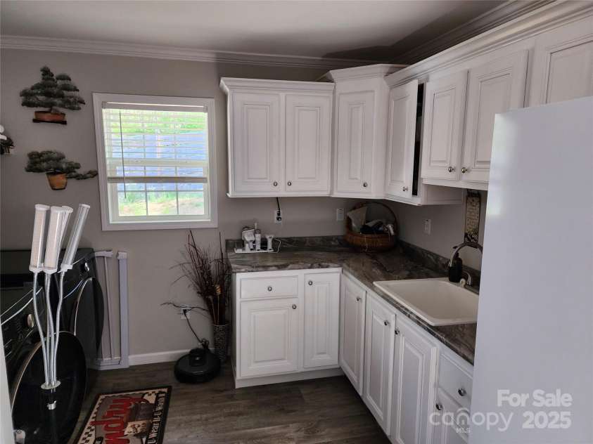 583 Cane Branch Road, Burnsville, NC 28714.  MLS# CAR4251066, YatesRealty ID 15423. Laundry room with sink and storage