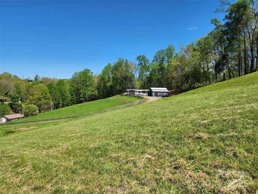 583 Cane Branch Road, Burnsville, NC 28714.  MLS# CAR4251066, YatesRealty ID 15423. Looking at house from the hay field/pasture