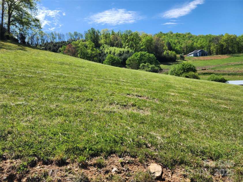 583 Cane Branch Road, Burnsville, NC 28714.  MLS# CAR4251066, YatesRealty ID 15423. Looking at house from the hay/pasture