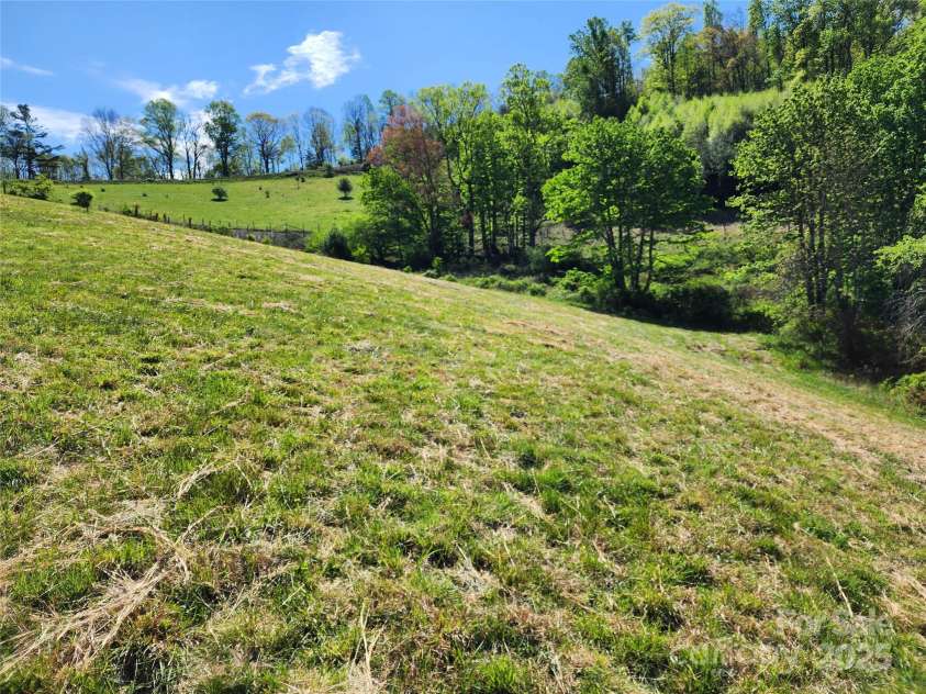 583 Cane Branch Road, Burnsville, NC 28714.  MLS# CAR4251066, YatesRealty ID 15423. Pasture/hay field looking east