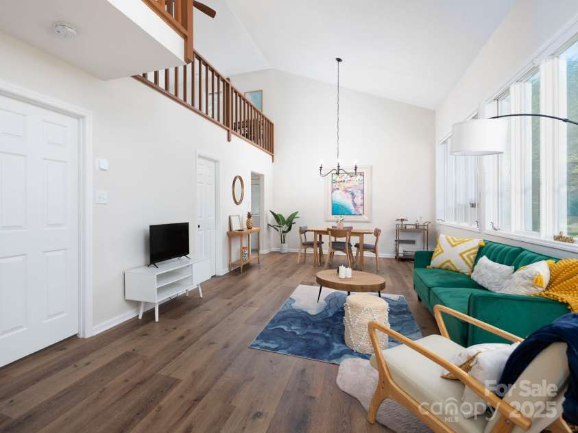 7728 Babe Stillwell Farm Road, Huntersville, NC 28078.  MLS# CAR4255046, YatesRealty ID 15464. Living area with wall of windows and vaulted ceiling.