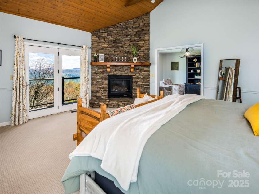 4344 Eagles Nest Road, Waynesville, NC 28786.  MLS# CAR4261425, YatesRealty ID 15485. PRIMARY BEDROOM WITH GAS LOG FIREPLACE