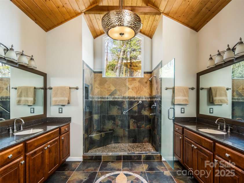 4344 Eagles Nest Road, Waynesville, NC 28786.  MLS# CAR4261425, YatesRealty ID 15485. SPACIOUS PRIMARY BATHROOM WITH SPA LIKE STEP IN SHOWER