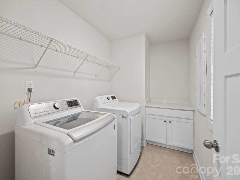 19823 Davidson Concord Road, Davidson, NC 28036.  MLS# CAR4347655, YatesRealty ID 15487. Convenient upstairs laundry room with folding table