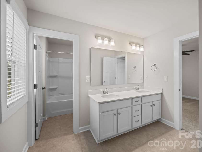 19823 Davidson Concord Road, Davidson, NC 28036.  MLS# CAR4347655, YatesRealty ID 15487. Freshly professionally painted Jack and Jill bathroom
