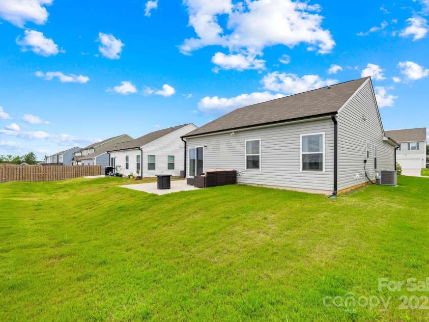 130 Slalom Street, Statesville, NC 28677.  MLS# CAR4264006, YatesRealty ID 15492. Side rear view of home