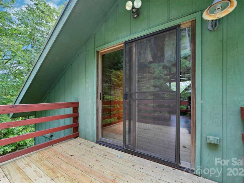 261 Franks Cove Road, Brevard, NC 28712.  MLS# CAR4263831, YatesRealty ID 15496. Upper Walkout Deck Overlooking Multiple Rock Outcroppings