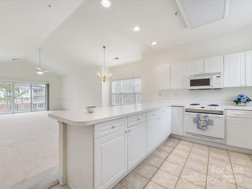 8759 Coralbell Lane, Charlotte, NC 28213.  MLS# CAR4231627, YatesRealty ID 15506. Kitchen opens to the great room