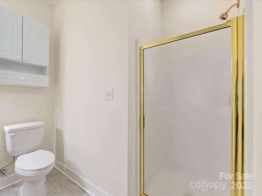8759 Coralbell Lane, Charlotte, NC 28213.  MLS# CAR4231627, YatesRealty ID 15506. Shower and laundry closet in this bath