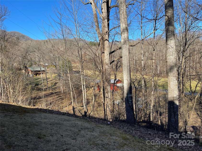 220 Frosty Ridge Road, Sylva, NC 28779.  MLS# CAR4212144, YatesRealty ID 15510. The east side of the house provides a scenic view of pasture and mountain range.