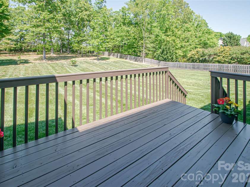 1325 Linden Glen Drive, Matthews, NC 28104.  MLS# CAR4370381, YatesRealty ID 15517. Deck overlooks expansive backyard.  