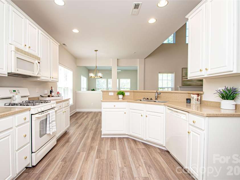 1325 Linden Glen Drive, Matthews, NC 28104.  MLS# CAR4370381, YatesRealty ID 15517. Spacious kitchen was recently painted white.  it has corium countertops.  