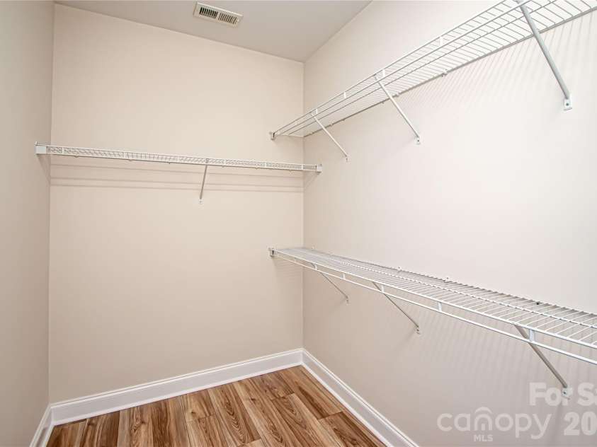 1325 Linden Glen Drive, Matthews, NC 28104.  MLS# CAR4370381, YatesRealty ID 15517. Spacious primary closet with new flooring.  