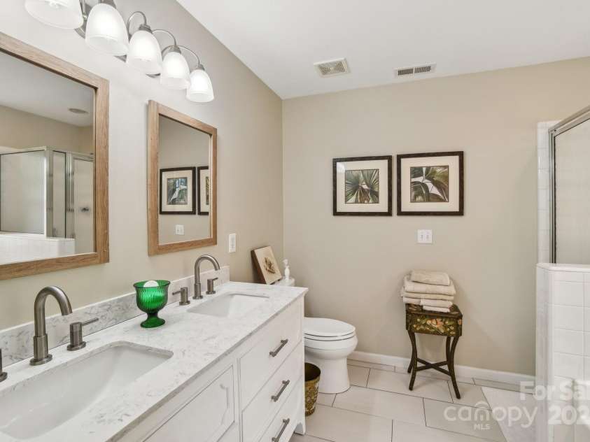 36 Planters Creek Road, Fletcher, NC 28732.  MLS# CAR4257762, YatesRealty ID 15540. Relaxing primary bath with dual vanities, walk-in shower and soaking tub