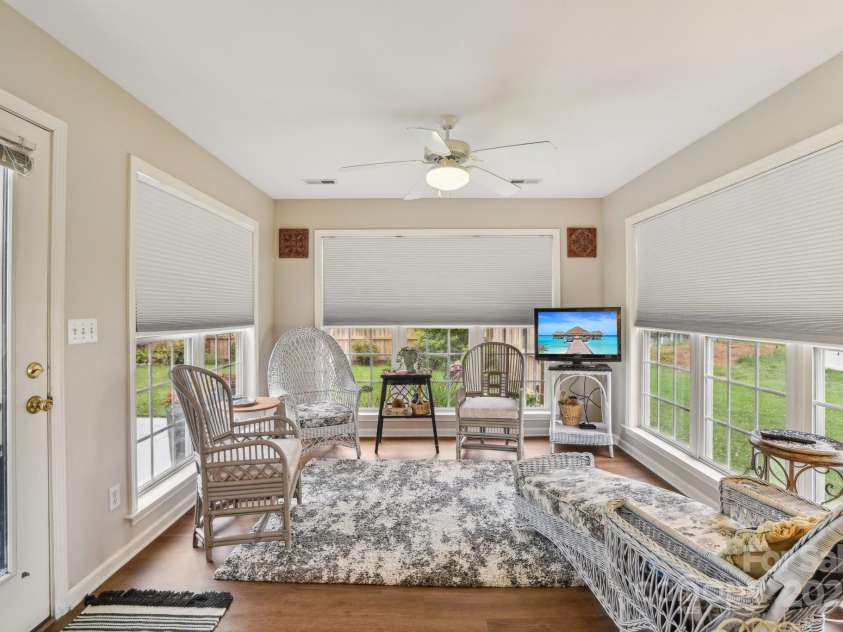 36 Planters Creek Road, Fletcher, NC 28732.  MLS# CAR4257762, YatesRealty ID 15540. This inviting sunroom offers panoramic backyard views through large windows, filling the space with natural light
