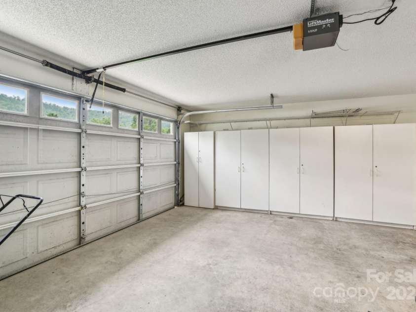 36 Planters Creek Road, Fletcher, NC 28732.  MLS# CAR4257762, YatesRealty ID 15540. Two-car garage with plenty of room for vehicles, storage, and gear