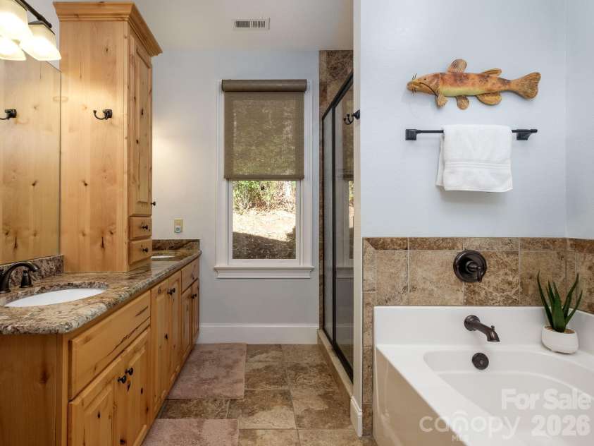 674 Soquili Drive, Brevard, NC 28712.  MLS# CAR4352829, YatesRealty ID 15540. Primary Bath with a soaking tub and stand up shower