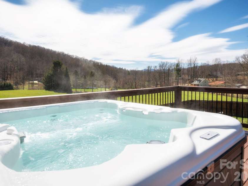 311 Hookers Gap Road, Candler, NC 28715.  MLS# CAR4358991, YatesRealty ID 15544. Soak While Soaking It All In