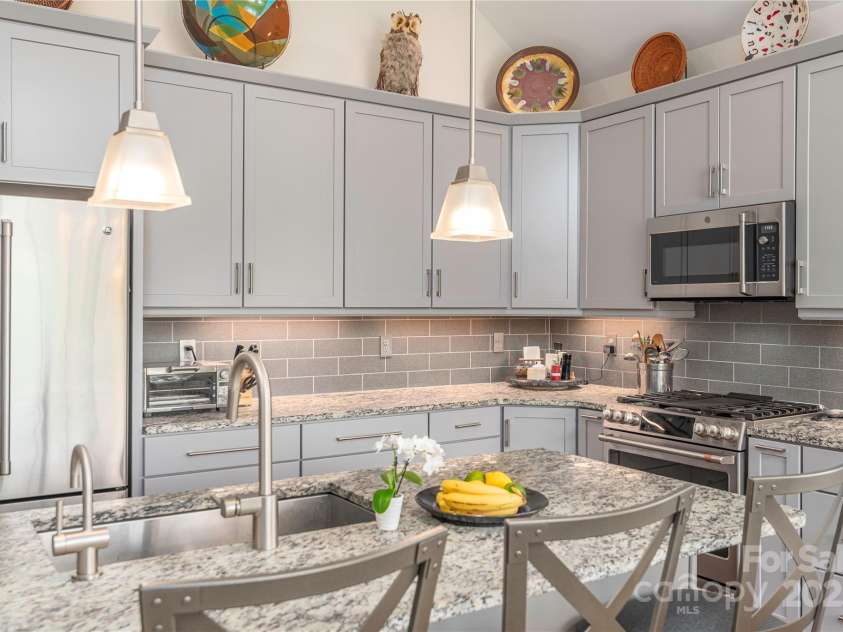 5 Buckhorn Gap Road, Biltmore Lake, NC 28715.  MLS# CAR4261479, YatesRealty ID 15544. Roll-out drawers, leather granite, bookshelves, hot water dispenser, GE Cafe series appliances....this kitchen has it all!