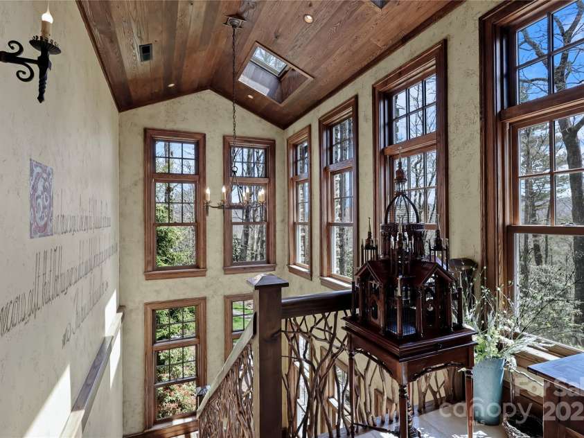 205 Indrio Road, Blowing Rock, NC 28605.  MLS# CAR4245602, YatesRealty ID 15556. Landing leading down to lower level; Flower Room